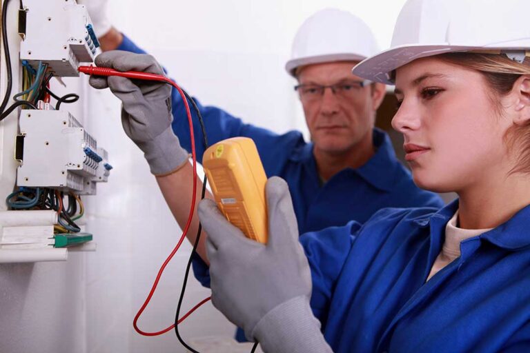 An electrician inspecting a home's circuit breaker panel with labeled switches.