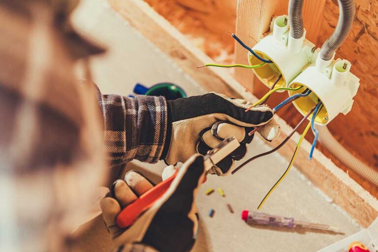 A homeowner watches a ceiling light flicker while an electrician checks the nearby electrical panel. KEYWORDS: ["flickering ceiling light", "residential electrical panel", "electrician inspecting wiring"]